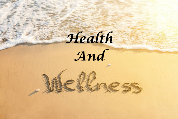 Sand and surf with Health and Wellness written in the sand